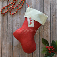 Red burlap Christmas stocking with cream satin cuff and personalized name hanging tag